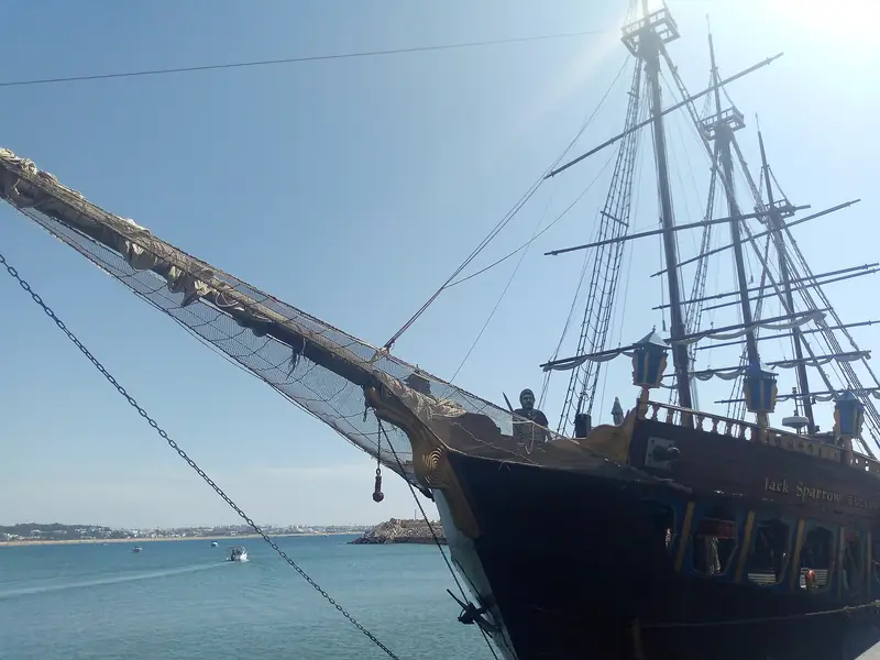 A traditional-style wooden sailing ship moored in Agadir Marina